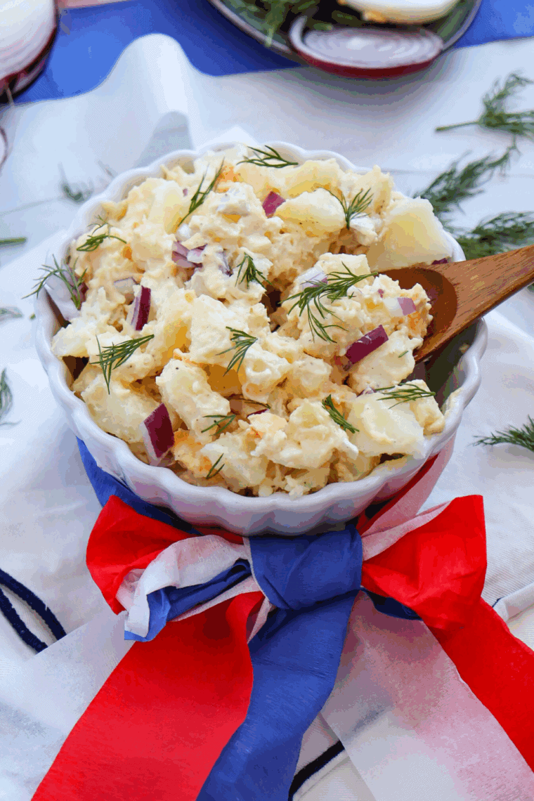 Bowl of Red, White and Blue Potato Salad on kitchen table.