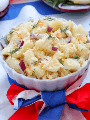 Red, White and Blue Potato Salad, featuring creamy potatoes, fresh cherry tomatoes, and blueberries, perfect for summer BBQs and patriotic celebrations.
