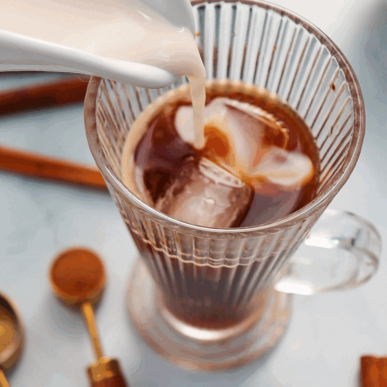 Add the heated milk on top of the coffee mixture.
