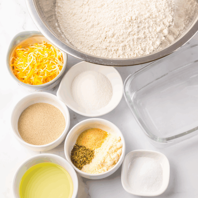 Ingredients needed for Subway Bread Recipe (Italian Herb and Cheese Copycat) on kitchen table.