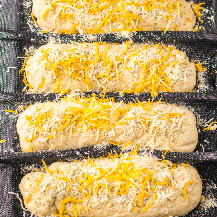 Shaping the dough into long, oval loaves ready for baking.