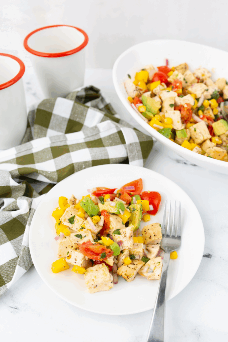 Air Fryer Avocado Chicken Mango Salad served in a bowl with grilled chicken, avocado, mango, corn, and tomatoes over fresh greens.