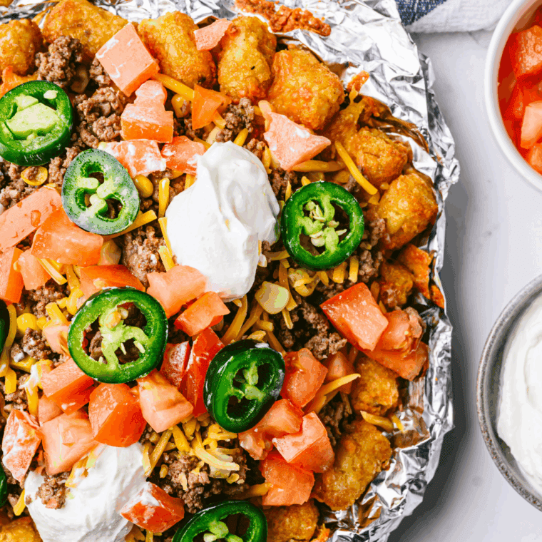 Plate of Air Fryer Beef Totchos with ground beef, melted cheese, and toppings