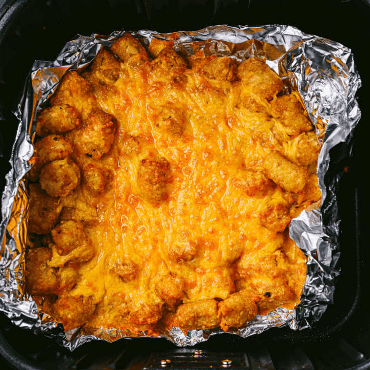 Melted cheese on top of the tater tots.
