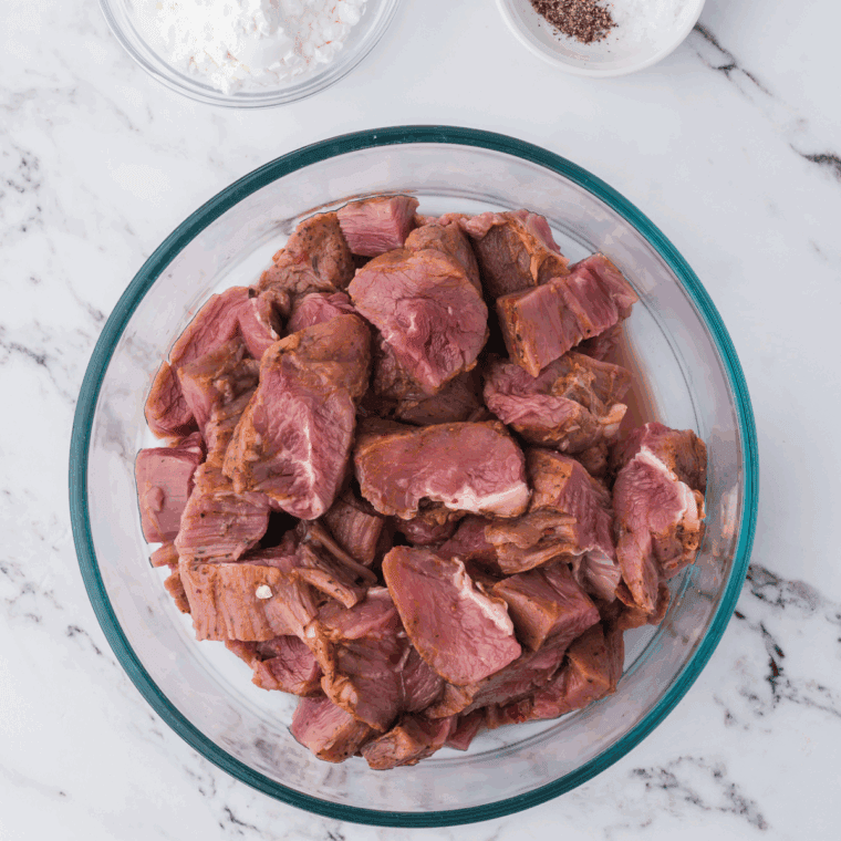 Add diced flank steak in a large mixing bowl.