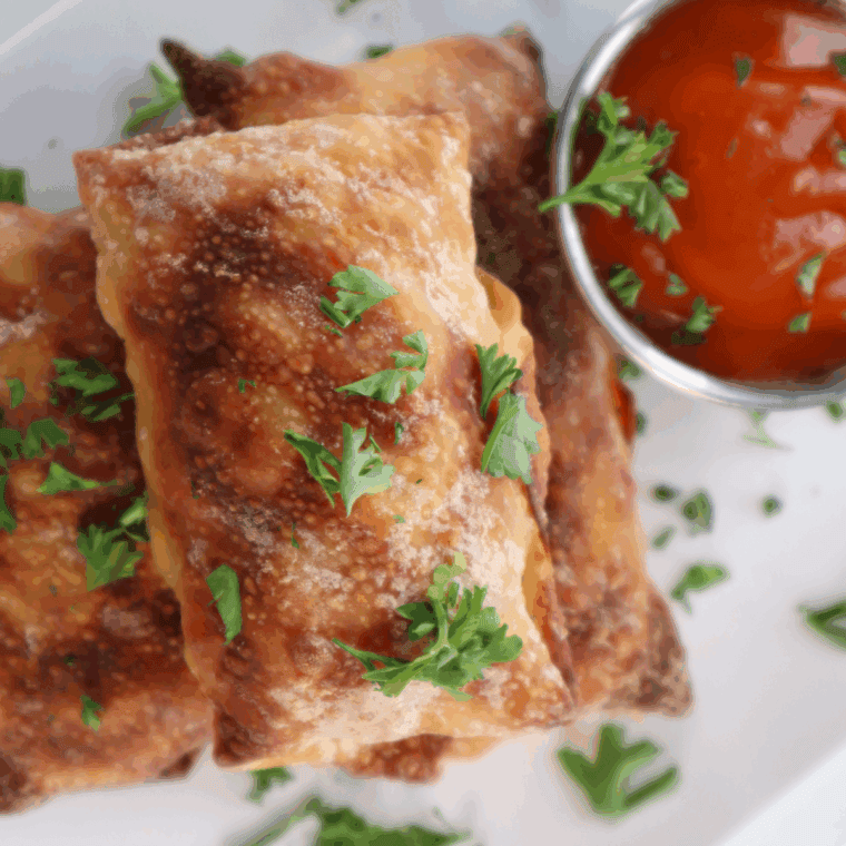 Plate of Air Fryer Mac And Cheese Egg Rolls with dipping sauce.