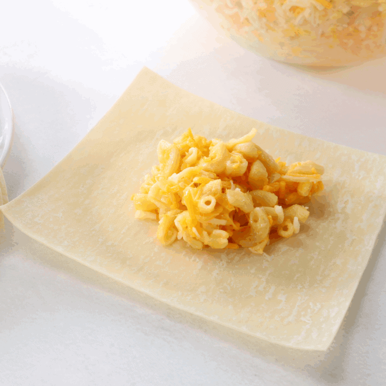 Place macaroni and cheese in the center of the egg roll wrapper.
