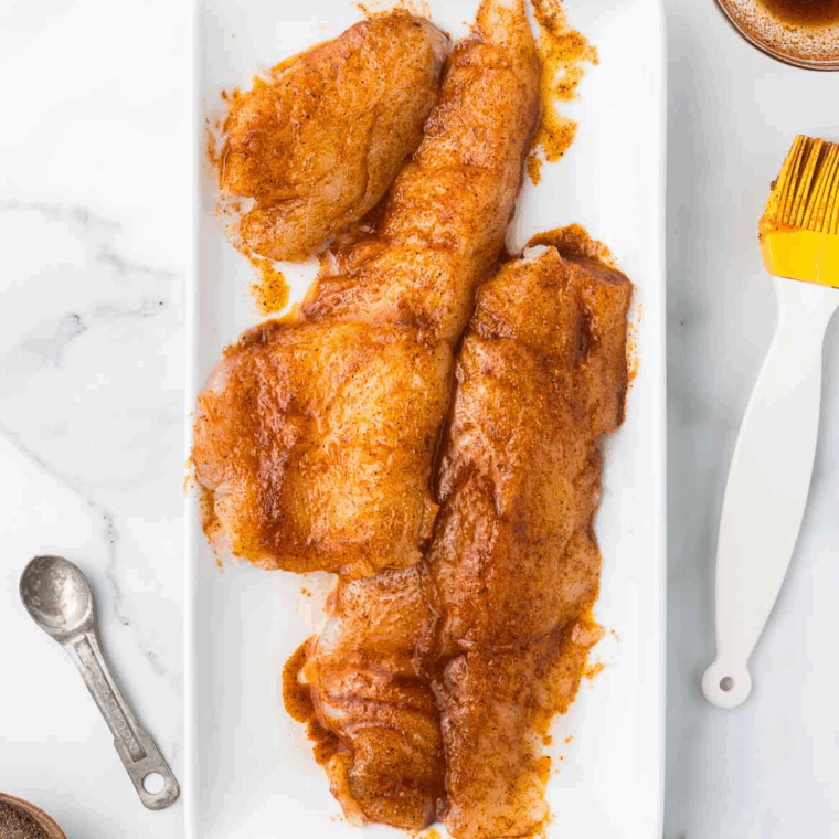 Seasoned monkfish fillets brushed with olive oil and spices.