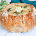 Bowl of creamy Applebee’s broccoli cheese soup topped with shredded cheddar