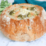 Bowl of creamy Applebee’s broccoli cheese soup topped with shredded cheddar
