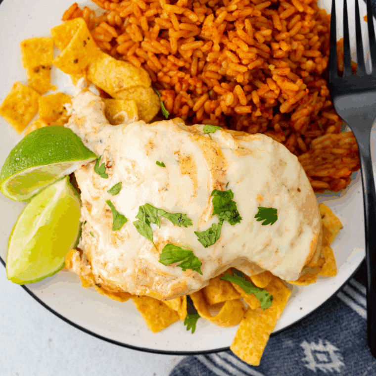 Grilled Fiesta Lime Chicken topped with melted cheese and creamy lime ranch sauce served over crispy tortilla strips.