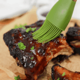 Bottle of homemade Applebee’s honey BBQ sauce with a bowl of sauce for dipping
