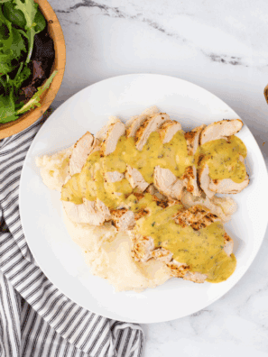 Homemade Applebee’s honey mustard sauce in a small dipping bowl with chicken tenders.