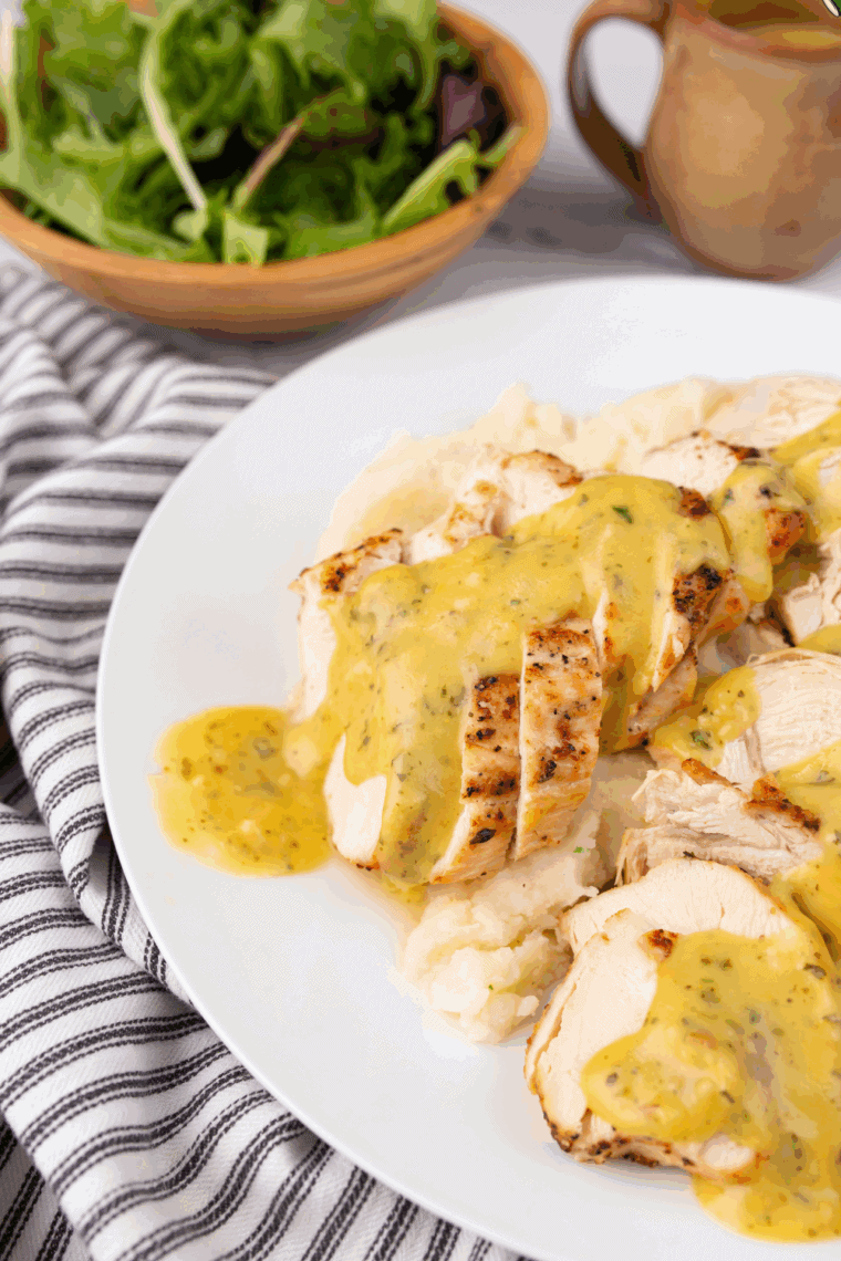 A bowl of cream apples with honey mustard sauce and a spoon can be dipped in.