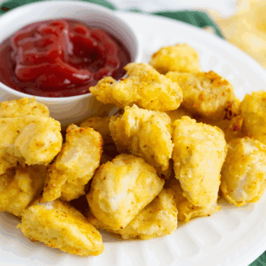 Homemade Arby’s Bronco Berry Sauce in a dipping bowl next to jalapeño poppers