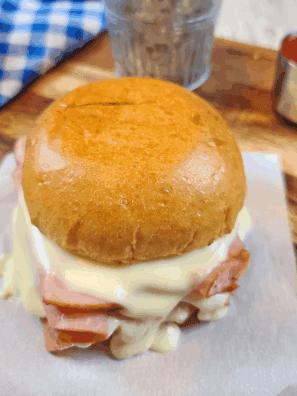 Homemade Arby’s ham and cheese melt with gooey cheese on a toasted bun.