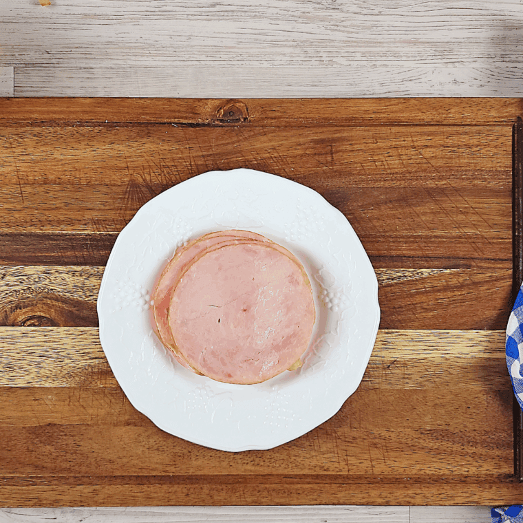Place the ham and cheese onto the hamburger bun, before air frying or cooking.