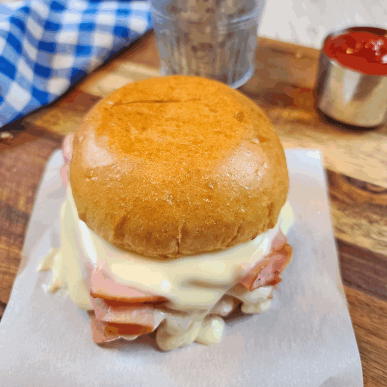 Homemade Arby’s ham and cheese melt with gooey cheese on a toasted bun.