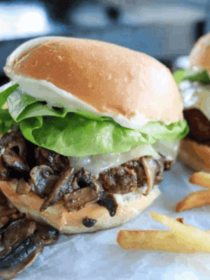 Bowl of creamy Arby’s Horsey Sauce copycat next to roast beef sandwich.