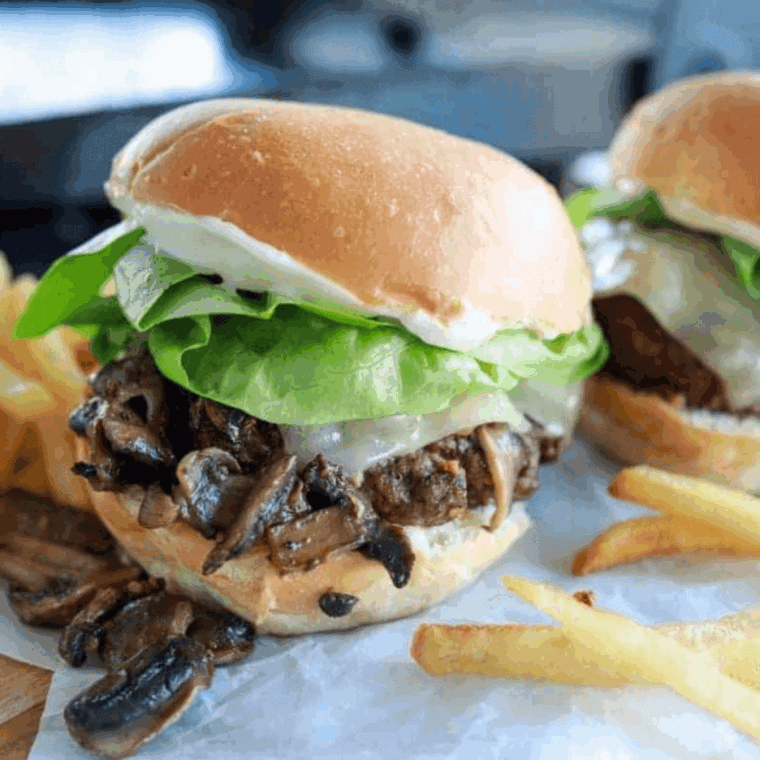 Bowl of creamy Arby’s Horsey Sauce copycat next to roast beef sandwich.
