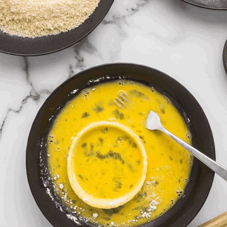 Two bowls with dry coating mix and egg-buttermilk wash.
