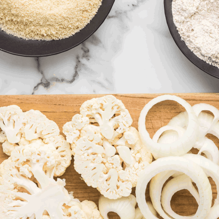 Thick onion rings soaking in buttermilk for tenderness.
