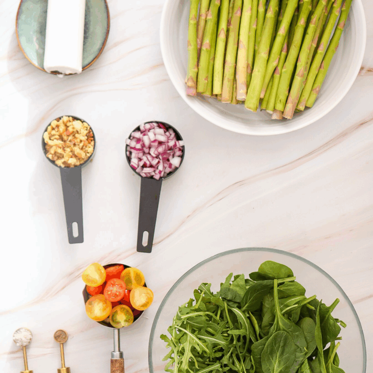 Ingredients needed for Asparagus Salad with Goat Cheese  on kitchen table.