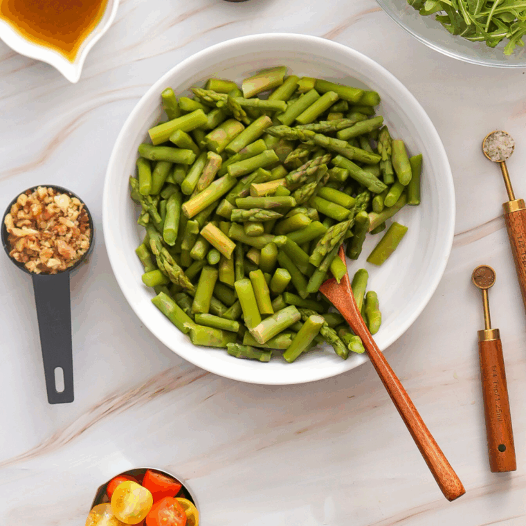 Bright green asparagus in a pot of boiling water, ready to be transferred to an ice bath.