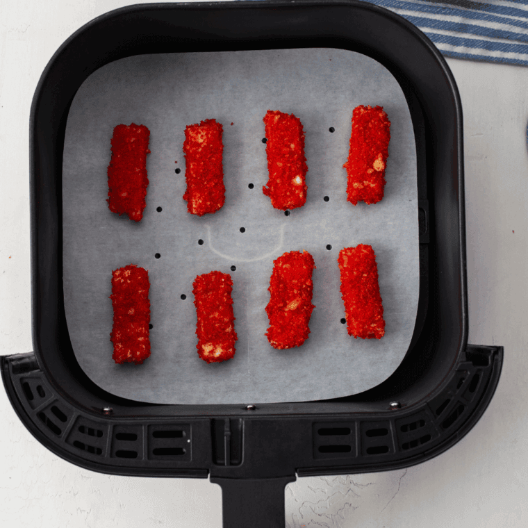 Place coated mozzarella sticks into the air fryer basket.