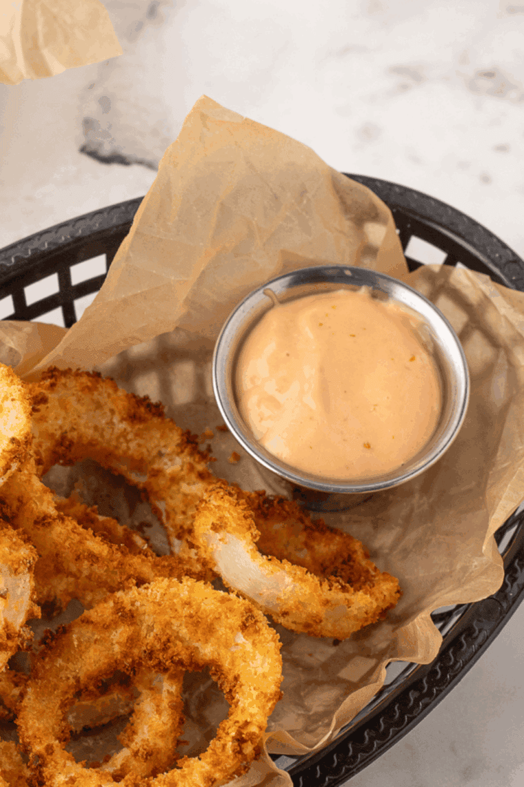 Homemade Burger King Zesty Sauce served with golden onion rings.