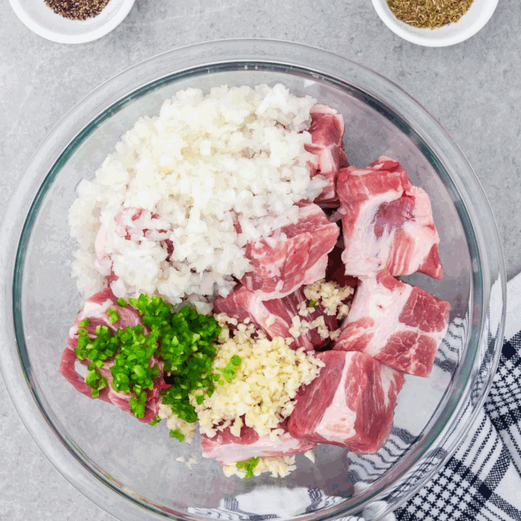 Marinating the pork in a large mixing bowl with the marinade ingredients.