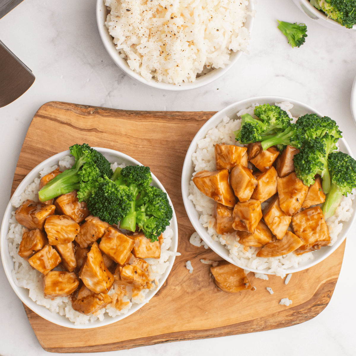 Grilled chipotle honey chicken sliced on a plate, served with lime and fresh cilantro.