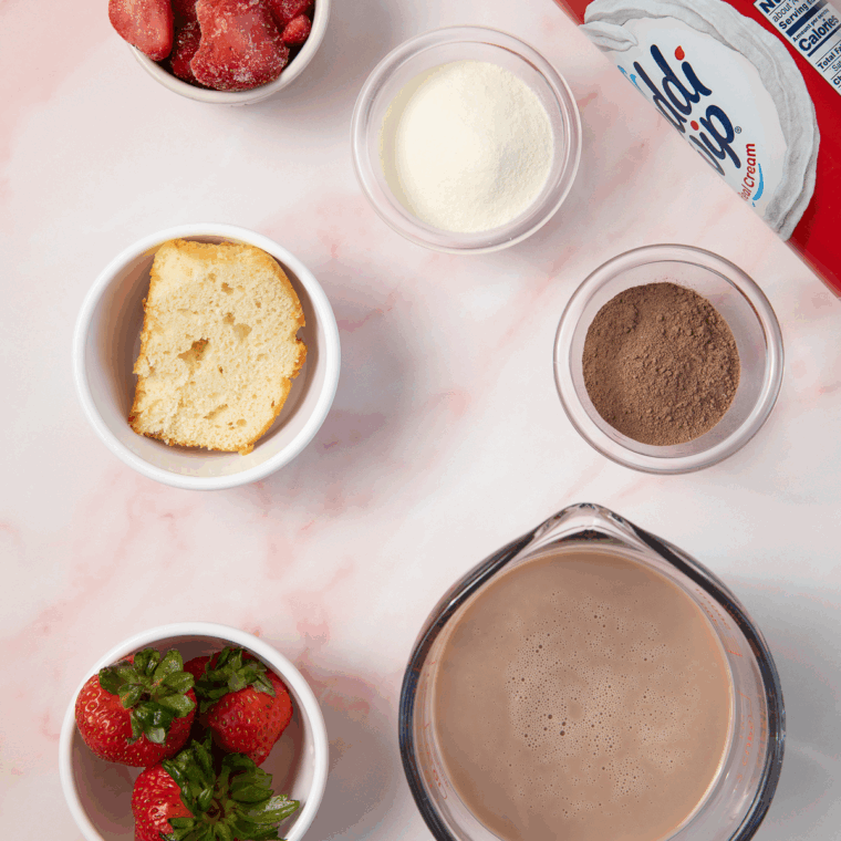 Ingredients needed for Chocolate Covered Strawberry Protein Ice Cream (Ninja Creami) on kitchen table.