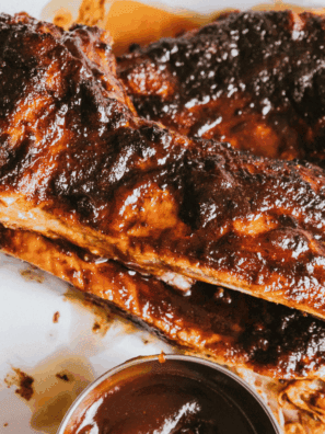 Homemade A&W BBQ sauce in a glass jar with brush on side
