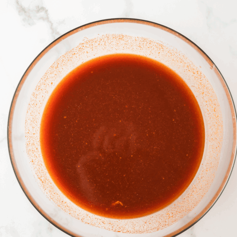 Ingredients for A&W BBQ sauce simmering in a medium saucepan
