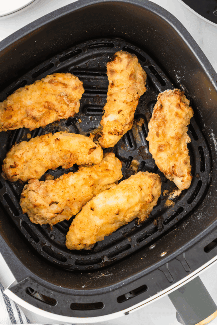 Cooked Copycat Applebee’s Chicken Tenders in the air fryer basket.
