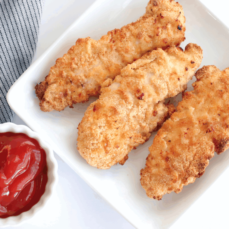 Golden crispy homemade chicken tenders served with dipping sauce