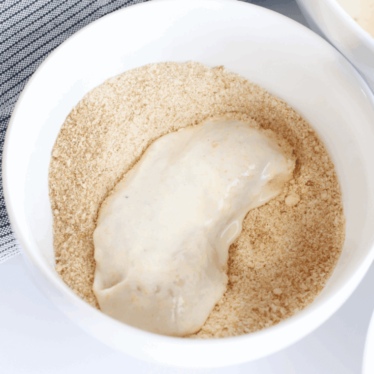 Place the chicken into the flour seasoned chicken coating mix.