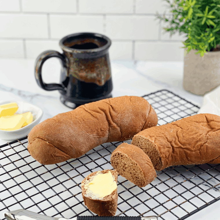 Freshly baked copycat Cheesecake Factory brown bread loaf topped with oats.