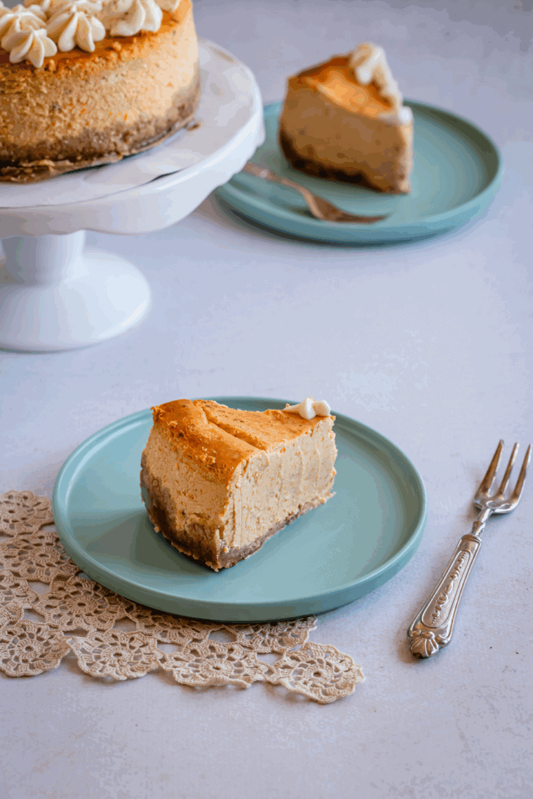Copycat Cheesecake Factory Pumpkin Cheesecake topped with whipped cream and sprinkled spices, perfect for fall celebrations.