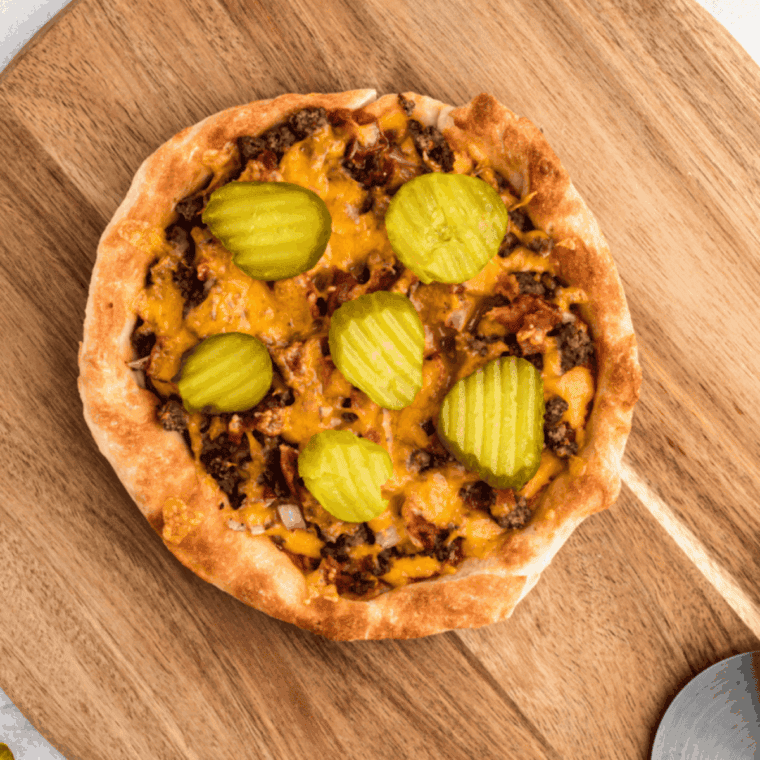 Cooked Copycat Domino's Cheeseburger Pizza Recipe on the cutting board.