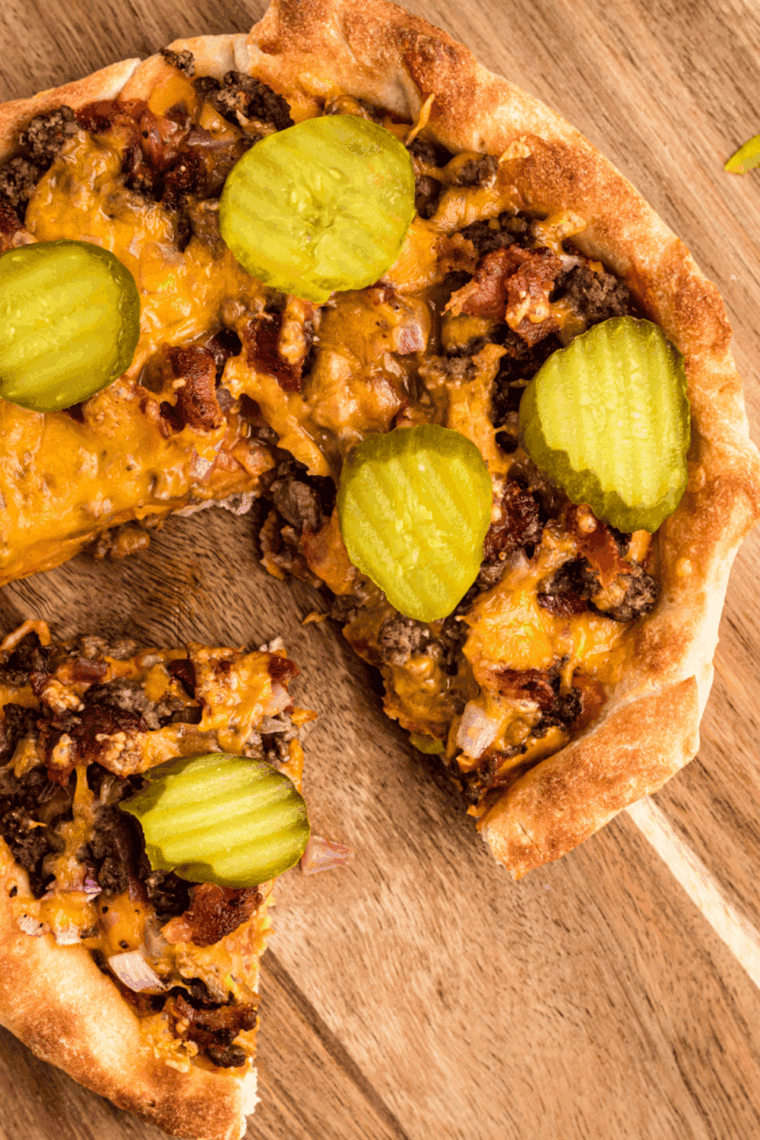 Homemade Domino’s-style cheeseburger pizza with ground beef, melted cheddar, pickles, and onions on a crispy golden crust.