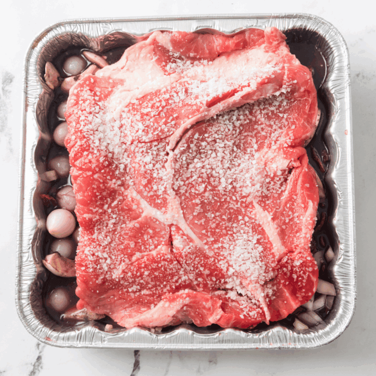 Place seasoned pot roast in the baking pan.