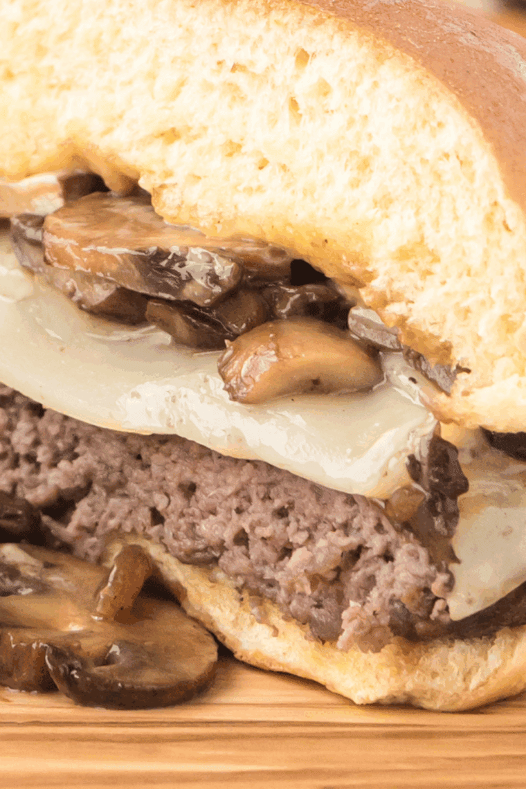 Homemade Hardee’s Mushroom Swiss Burger with melted Swiss cheese and mushrooms on a toasted bun.