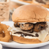 Juicy mushroom Swiss burger on a bun with melted cheese and sautéed mushrooms