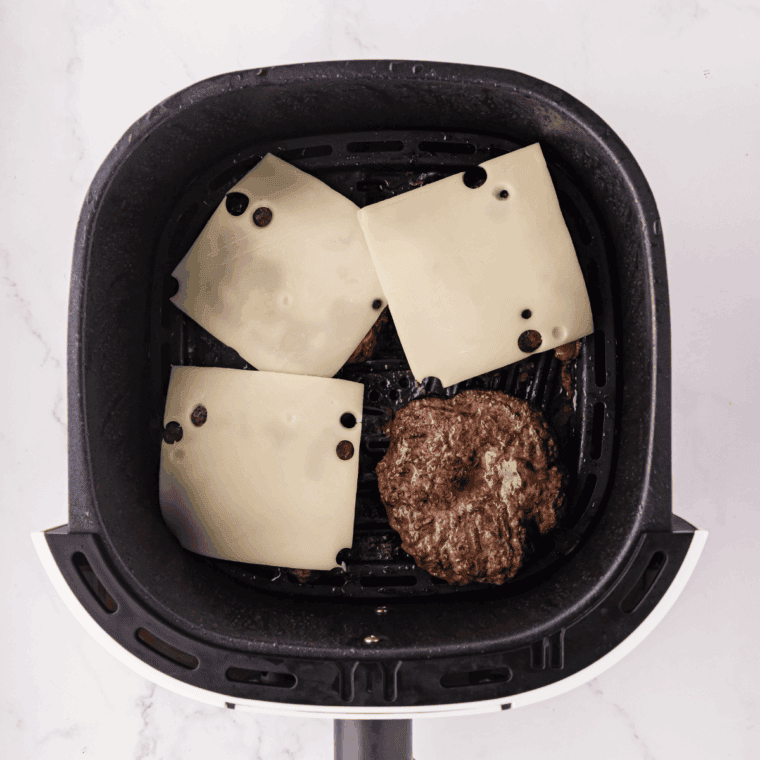 Place Swiss cheese on top of the cooked burger.