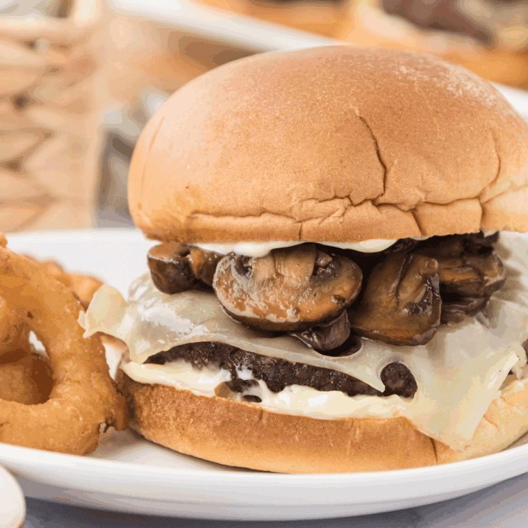 Juicy mushroom Swiss burger on a bun with melted cheese and sautéed mushrooms