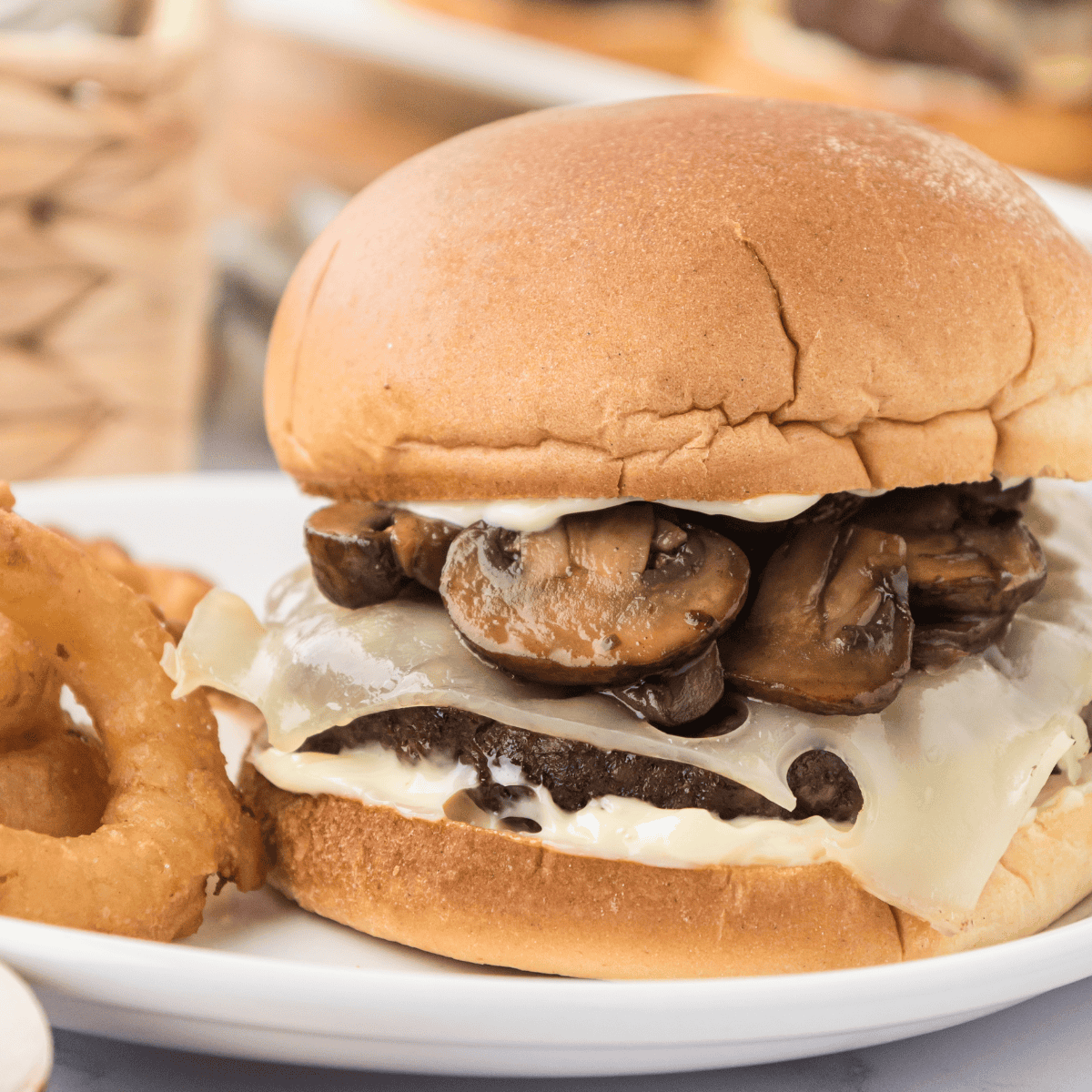 Juicy mushroom Swiss burger on a bun with melted cheese and saut&eacute;ed mushrooms