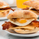 Homemade Starbucks-style bacon gouda breakfast sandwich on a toasted ciabatta bun with egg and melted cheese.