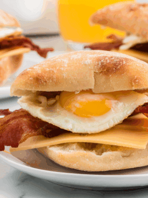 Homemade Starbucks-style bacon gouda breakfast sandwich on a toasted ciabatta bun with egg and melted cheese.